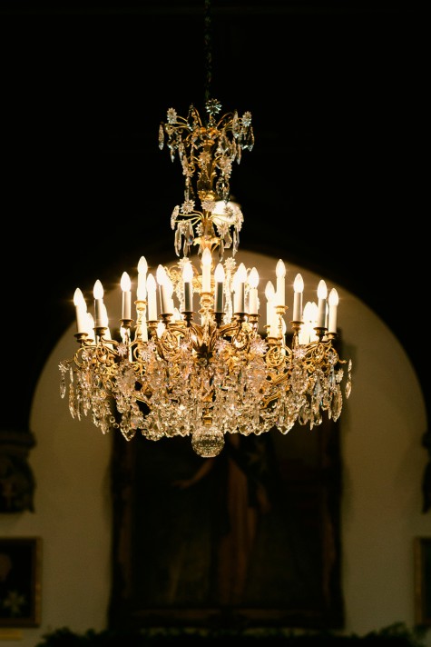 ALT="view of the Chapter Hall's large chandelier lit up"