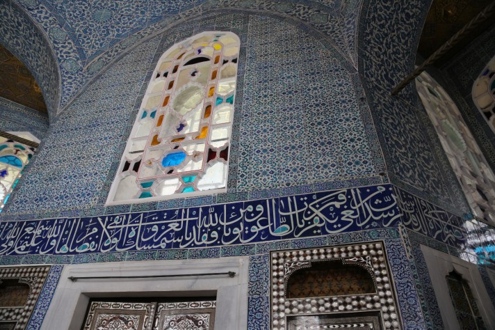 A vaulted room tiled with predominantly white and blue tiles