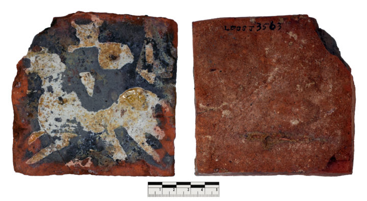 Image of the front and back of a square shaped tile. One corner of the tile has broken off. White horse and knight painted onto the red coloured tile.