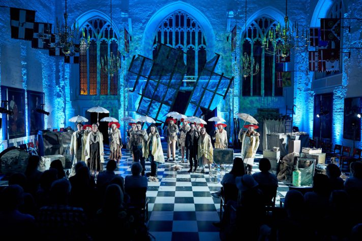 Actors raise umbrellas as part of the finale of Byre Opera's production of Xerxes