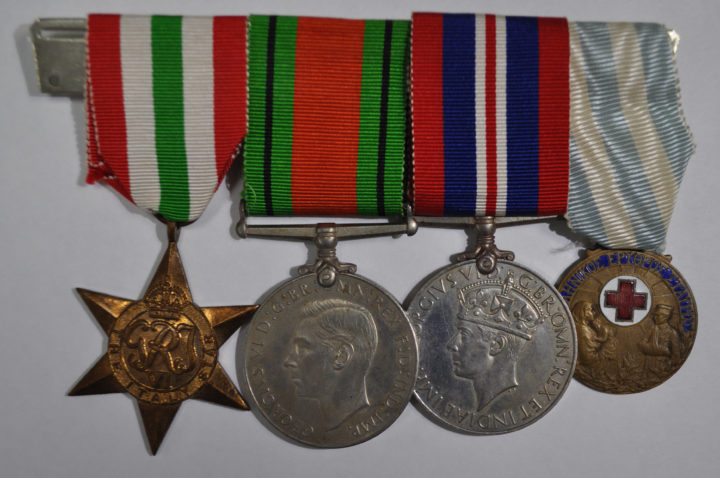 Set of four medals on ribbon mounted together, the obverse side. One copper star shaped medal, two silver round shaped medals and one bronze smaller round shaped medal with red cross enamel detail.