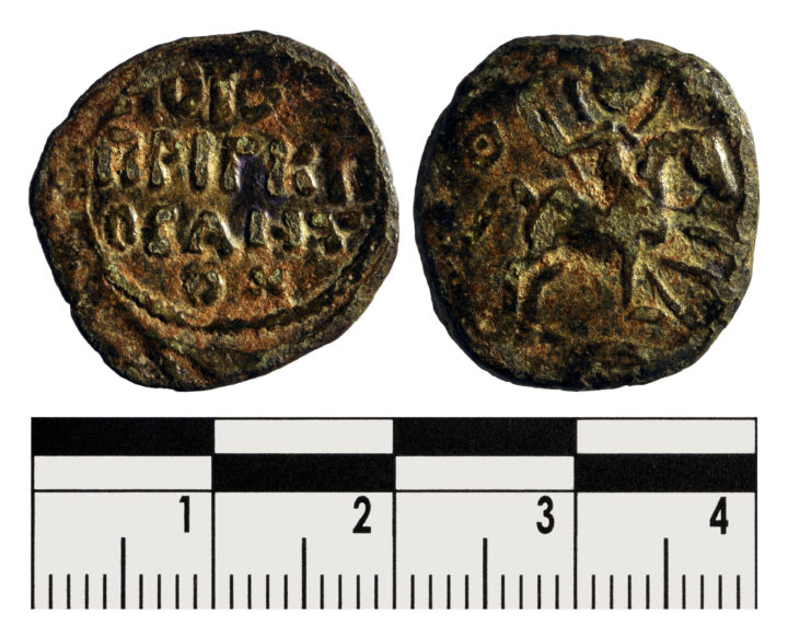 Two sides of a coin. One with an inscription, the other with St George on horseback holding a spear.