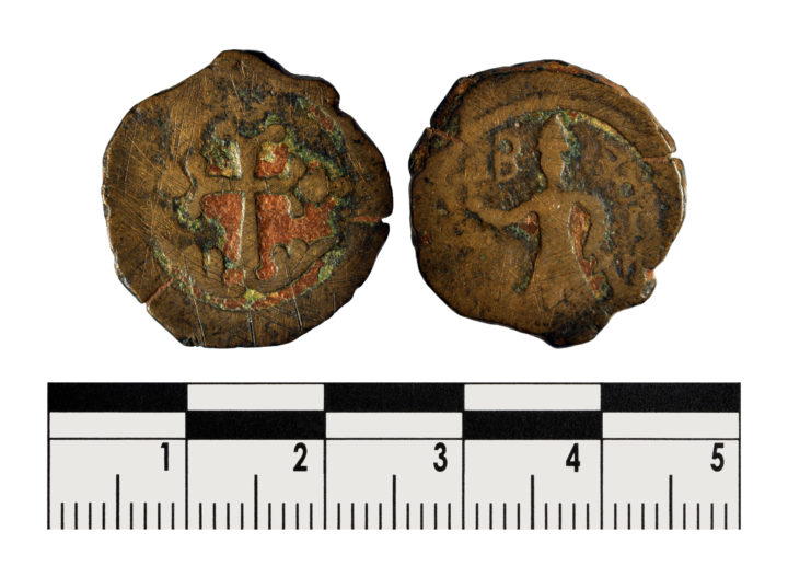Two sides of a copper coin, worn and scratched. One side depicting a cross, and the other a knight holding a cross aloft, and a sword lowered. A letter B is in the top left.