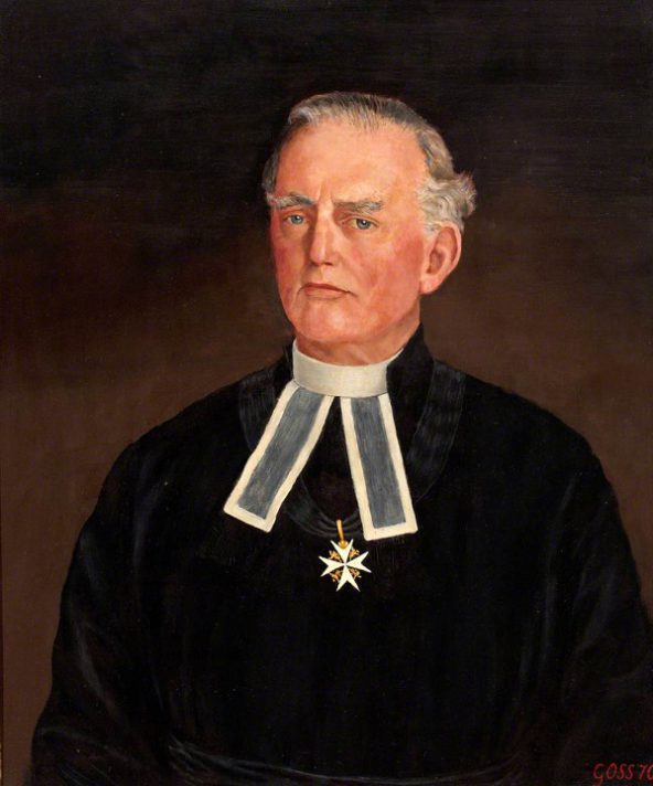 Photograph of a man in black clothing wearing the eight pointed cross around his neck and wearing bands