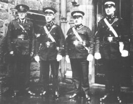 Black and white photograph of four men in St John uniform standing in a row.