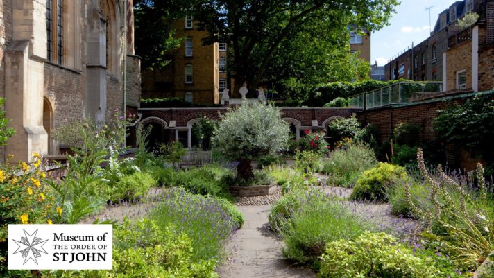 Photograph of a walled garden with a olive tree in the middle.