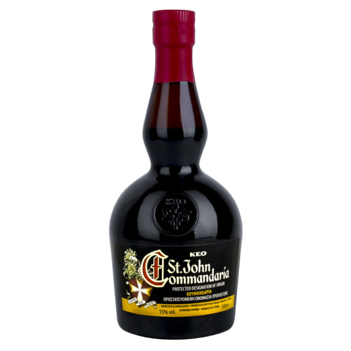 ALT="a black glass bottle with a red cap, the label on the front reads 'St John Commandaria' with the design including an eight-pointed cross"