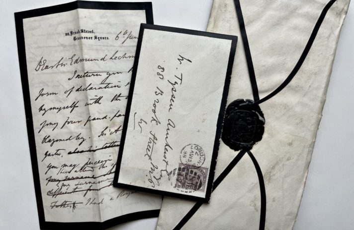Assorted opened and unopened letters with black detailing indicating a period of mourning. The unopened letter on the right has a black seal. 