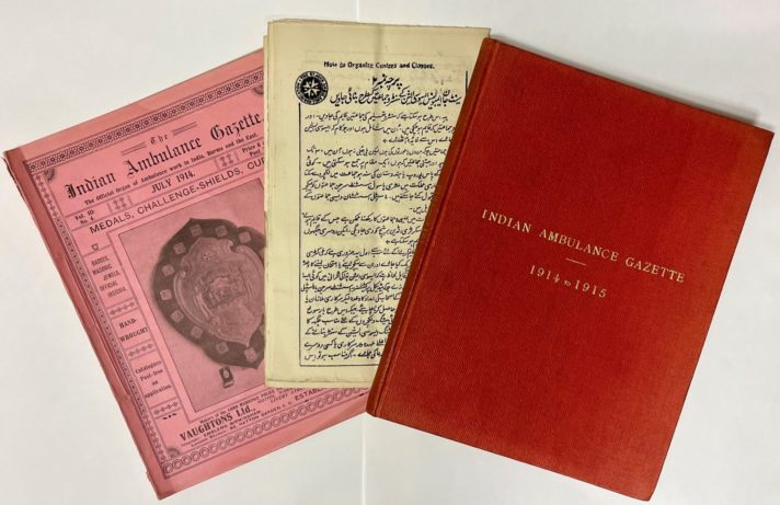 Fanned pink and red Indian Ambulance Gazette issues, 1914-1915. The left issue contains an image of a challenge shield. The central item is an instruction leaflet on 'how to organise centre and classes' written in Urdu. 