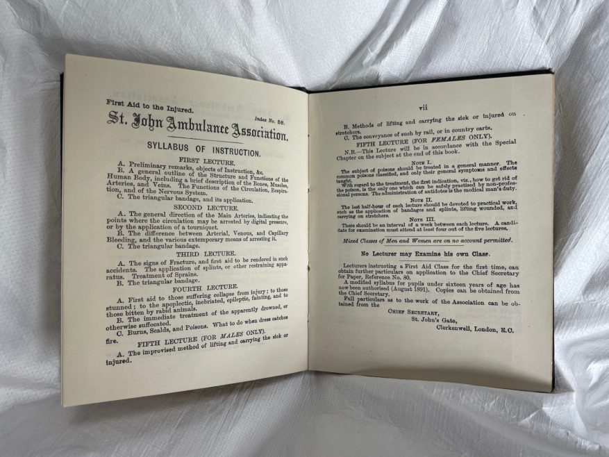 A photograph of pages from the 1893 edition of First Aid to the Injured.