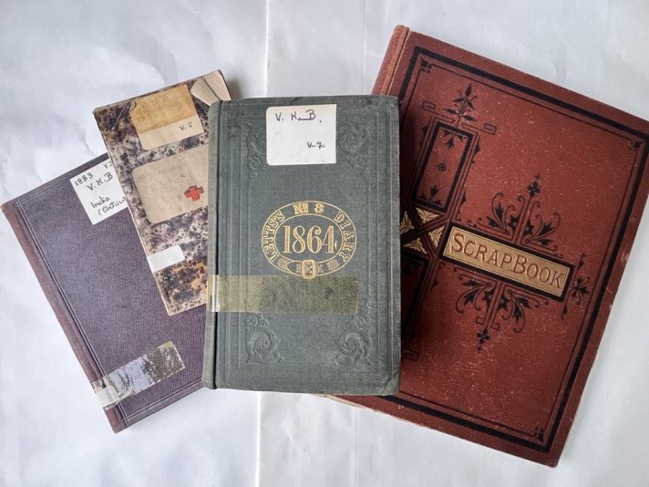 Three of Sir Vincent's diaries and one scrapbook dating from 1864 to 1880s. The diaries are in multicoloured note books and the scrapbook is red. 